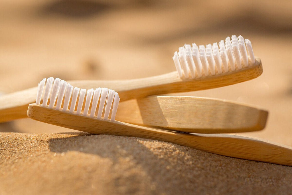 Eco-friendly personal care products, including bamboo toothbrushes and reusable cotton pads for sustainable self-care