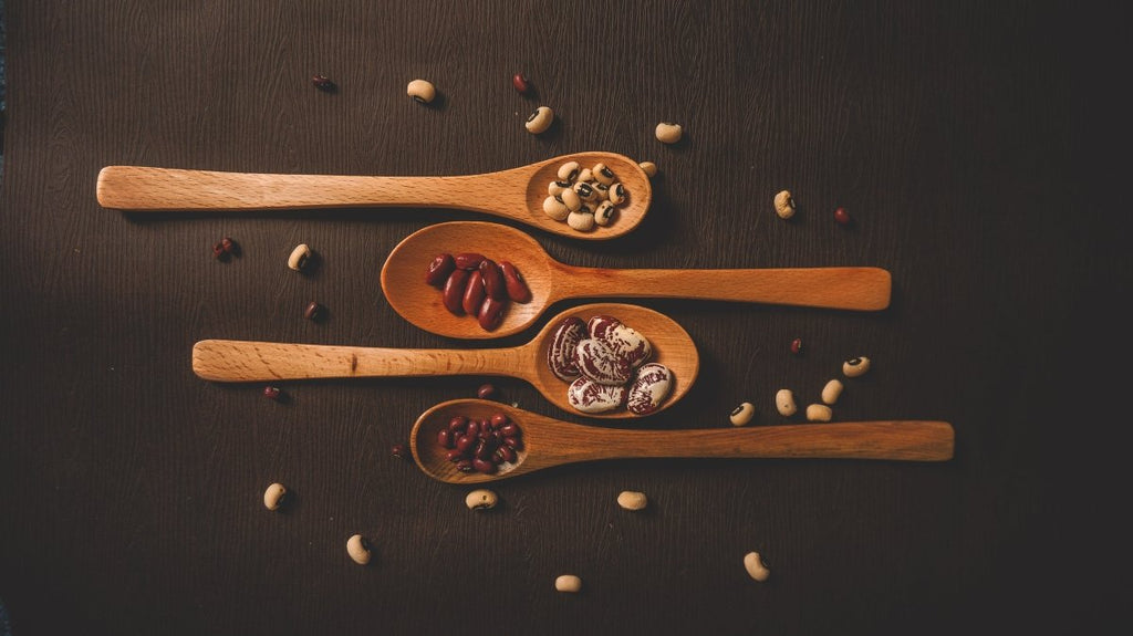 Eco-friendly reusable kitchen items for a sustainable home, including bamboo utensils and silicone food covers