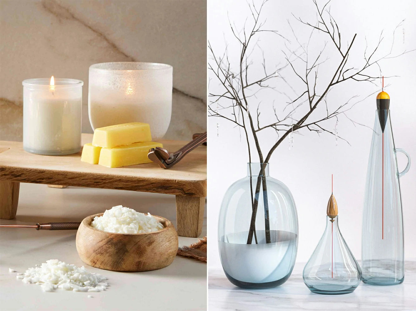 Candles, soap, and a bowl of white flowers on a wooden surface next to glass vases with branches.